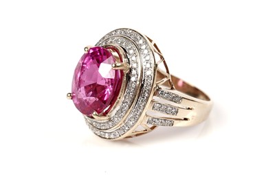 Lot 1167 - A pink sapphire and diamond cluster ring