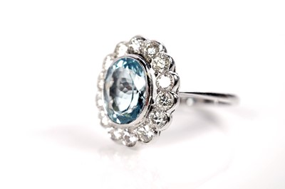 Lot 1168 - An aquamarine and diamond cluster ring