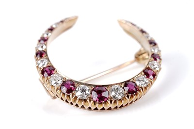 Lot 1172 - A ruby and diamond crescent brooch