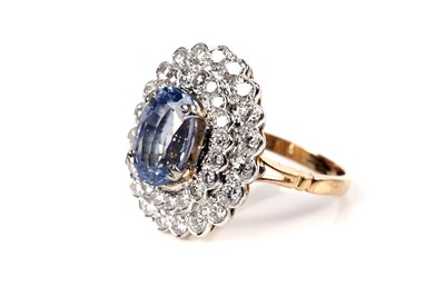 Lot 1178 - A sapphire and diamond cluster dress ring