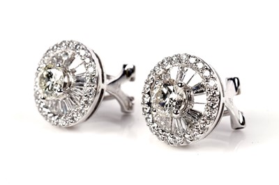 Lot 1180 - A pair of diamond cluster earrings