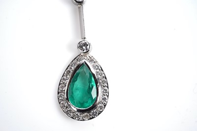 Lot 1182 - An emerald and diamond cluster pendant necklace