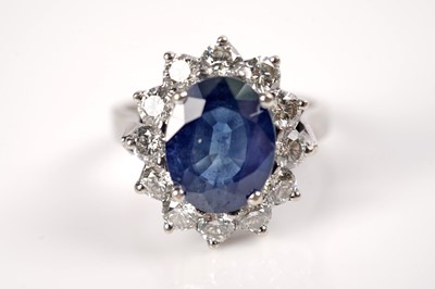Lot 1184 - A sapphire and diamond cluster ring