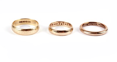 Lot 495 - An 18ct yellow gold wedding band; and two 9ct gold rings