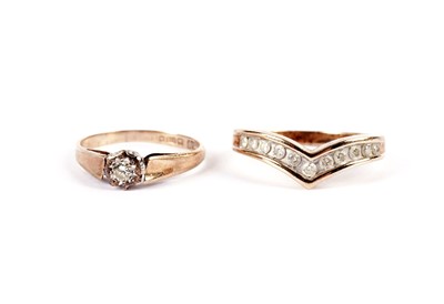Lot 503 - A solitaire diamond ring; and a diamond band