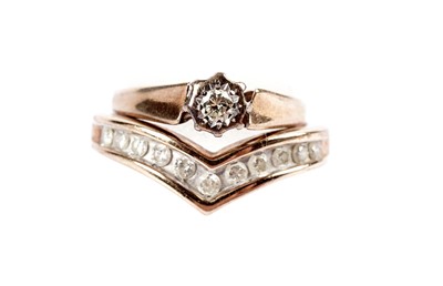 Lot 503 - A solitaire diamond ring; and a diamond band