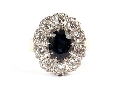 Lot 527 - A sapphire and diamond cluster ring