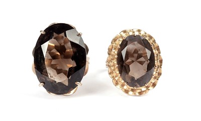 Lot 528 - Two smoky quartz dress rings