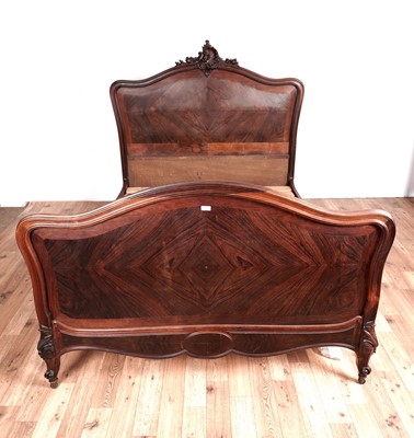 Lot 127 - An early 20th Century rosewood double bed with arched headboard