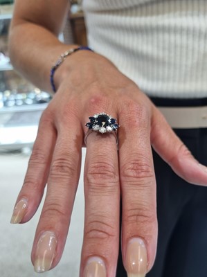 Lot 1124 - A sapphire and diamond dress ring
