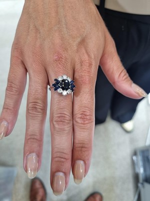 Lot 1124 - A sapphire and diamond dress ring