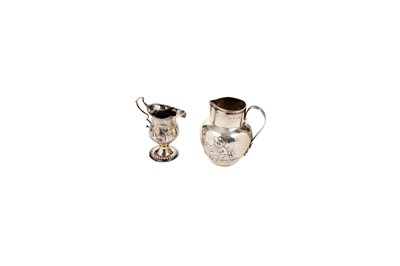 Lot 1453 - A George III embossed cream jug and another late Victorian jug