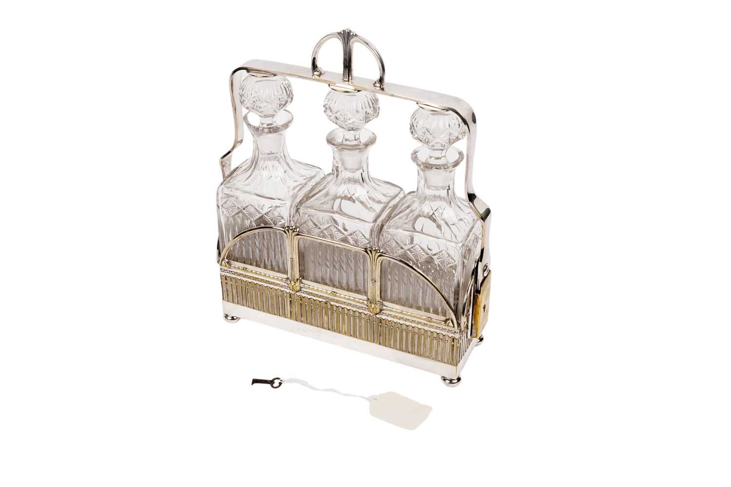 Lot 246 - A late 19th Century three bottle tantalus by WMF