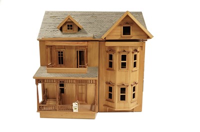 Lot 610 - A child's three-storey stained wood dolls house