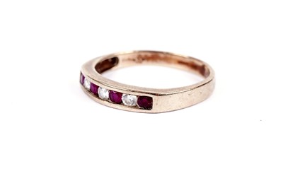 Lot 545 - A ruby and diamond half hoop eternity ring