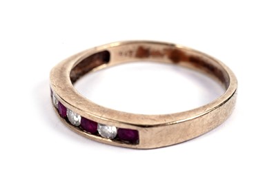 Lot 545 - A ruby and diamond half hoop eternity ring