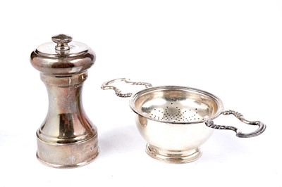 Lot 1339 - An Elizabeth II tea strainer and a peppermill