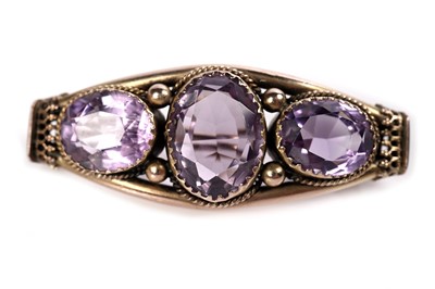 Lot 8 - An Etruscan Revival amethyst brooch