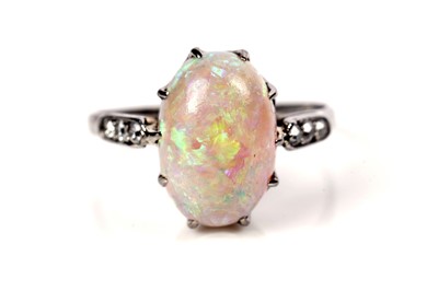 Lot 1202 - An opal and diamond dress ring