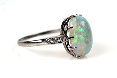 Lot 1202 - An opal and diamond dress ring