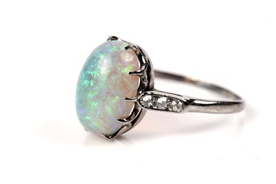 Lot 1202 - An opal and diamond dress ring