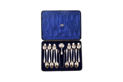 Lot 1574 - A Victorian cased set of twelve teaspoons, a caddy spoon and a pair of sugar tongs