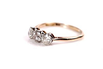 Lot 1151 - A three stone diamond ring