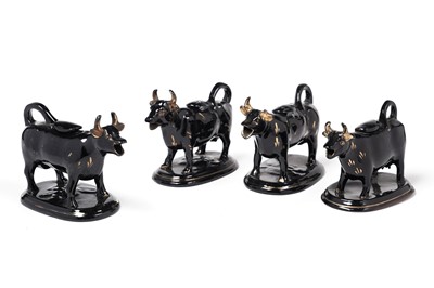 Lot 477 - Four Staffordshire black cow creamers