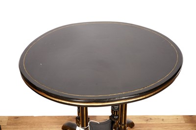 Lot 75 - An ebonised oval occasional table