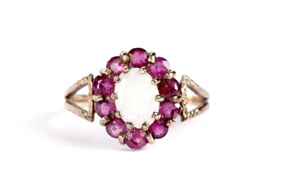 Lot 520 - An opal and ruby cluster ring