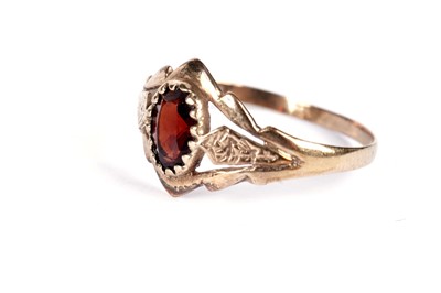 Lot 521 - A garnet three stone band; and another garnet ring