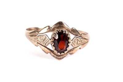 Lot 521 - A garnet three stone band; and another garnet ring