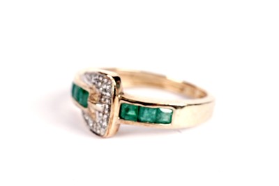 Lot 529 - An emerald and diamond belt buckle motif ring