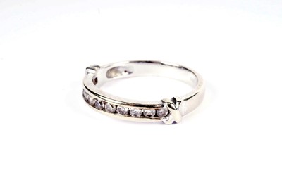 Lot 643 - A diamond half hoop eternity ring