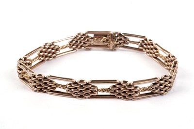 Lot 664 - A rose gold fancy gate-link bracelet