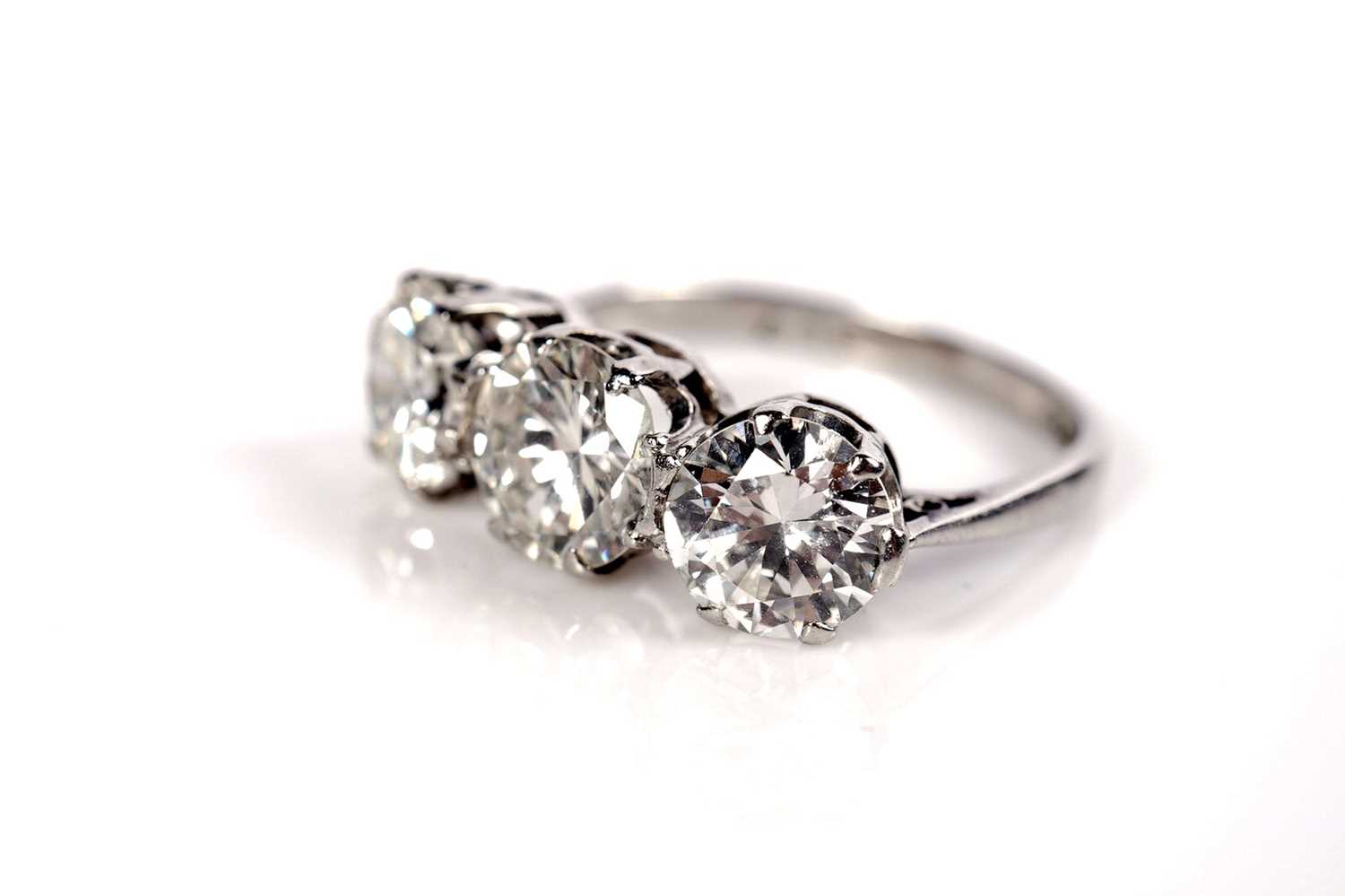 Lot 1208 - A three stone diamond ring