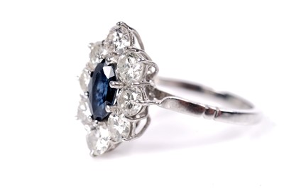 Lot 1212 - A sapphire and diamond cluster ring