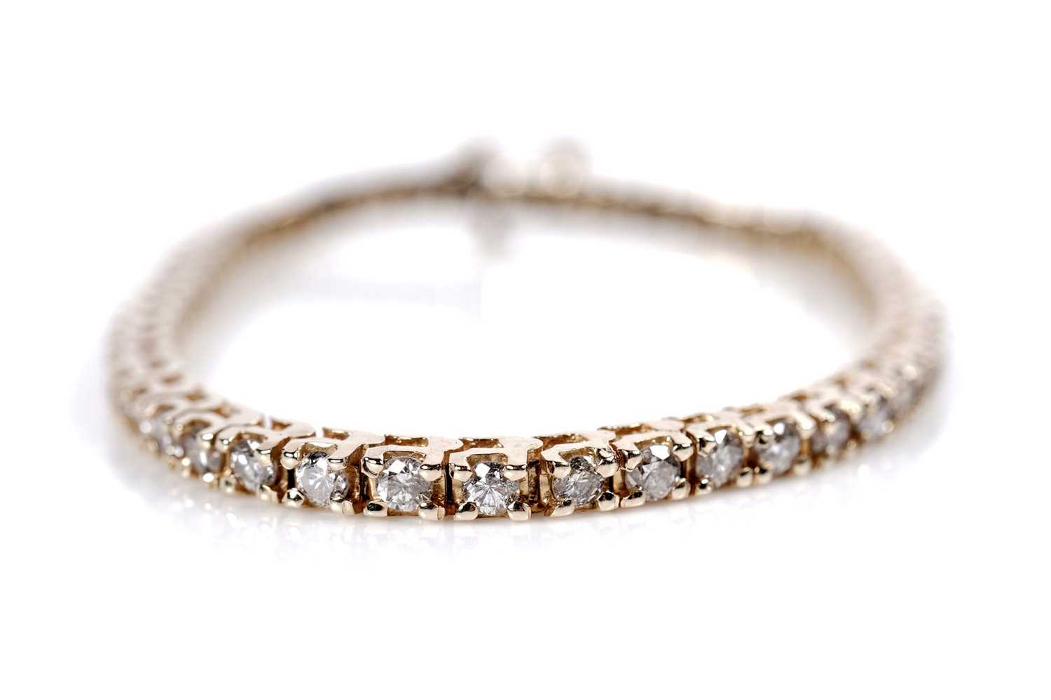 Lot 1216 - A diamond tennis bracelet