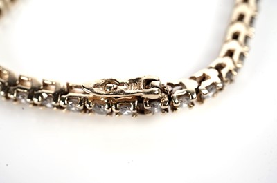 Lot 1216 - A diamond tennis bracelet