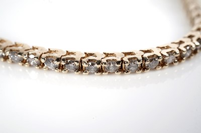 Lot 1216 - A diamond tennis bracelet