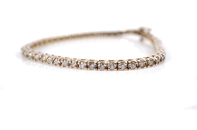 Lot 1216 - A diamond tennis bracelet