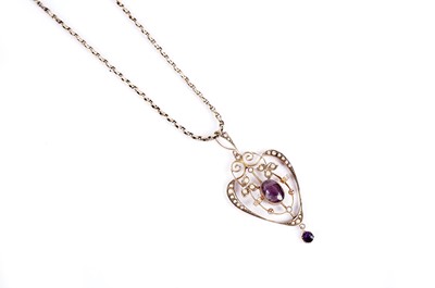 Lot 719 - An Edwardian amethyst and seed pearl drop pendant