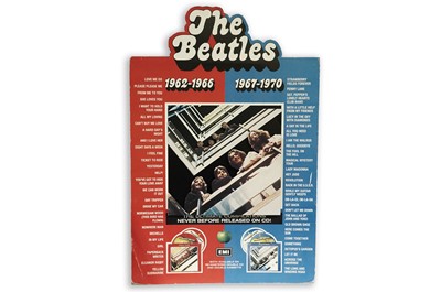 Lot 325A - An advertising board for The Beatles 1962-1966 and 1967-1970 compilation CDs and cassettes