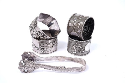 Lot 1445 - Four silver napkin rings and a pair of silver tongs