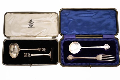 Lot 813 - A silver christening spoon and fork set; and a baby pusher and spoon set