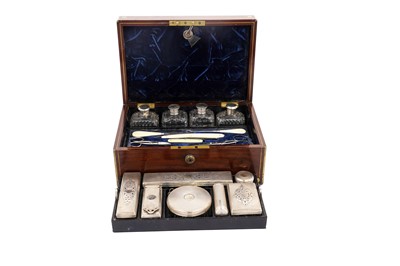 Lot 1741 - A Victorian brass bound mahogany toilet box fitted with various silver mounted items