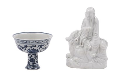 Lot 285 - A Chinese 'Blanc de Chine' figure; and a blue and white stem cup