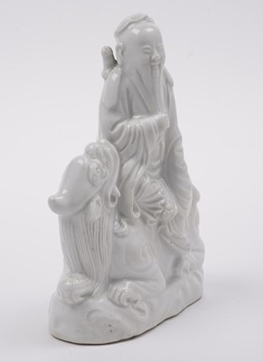 Lot 285 - A Chinese 'Blanc de Chine' figure; and a blue and white stem cup
