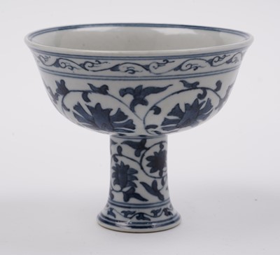 Lot 285 - A Chinese 'Blanc de Chine' figure; and a blue and white stem cup