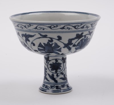 Lot 285 - A Chinese 'Blanc de Chine' figure; and a blue and white stem cup